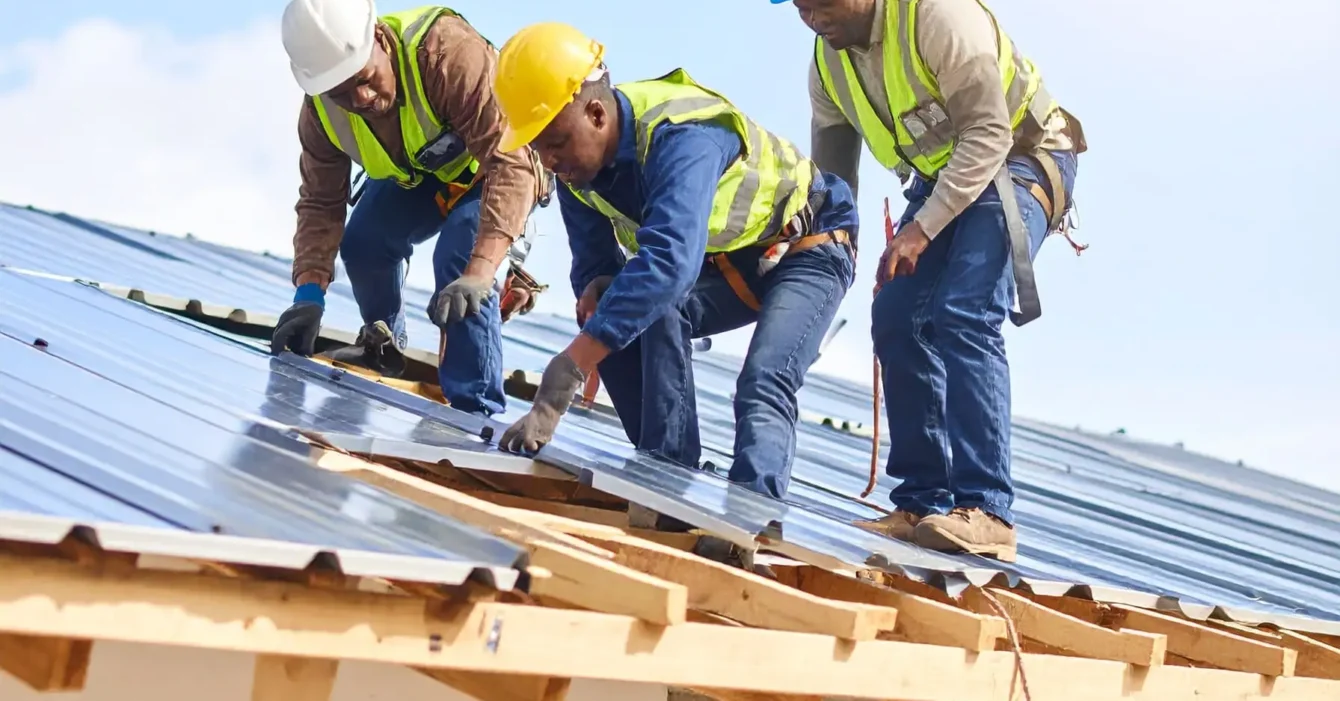 Firefly_A-realistic-image-of-African-construction-workers-installing-or-repairing-a-roof-on-a-648426