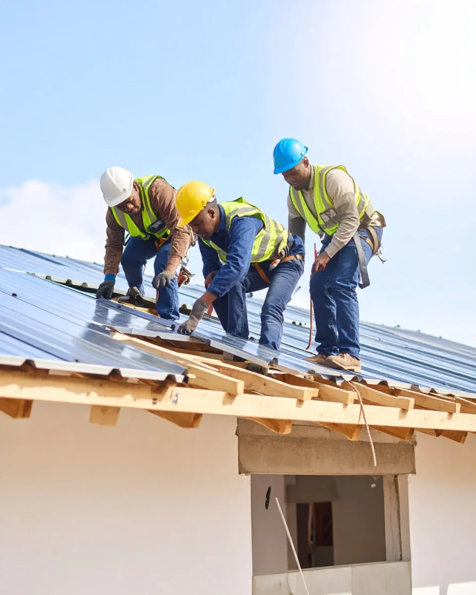 Firefly_A-realistic-image-of-African-construction-workers-installing-or-repairing-a-roof-on-a-648426